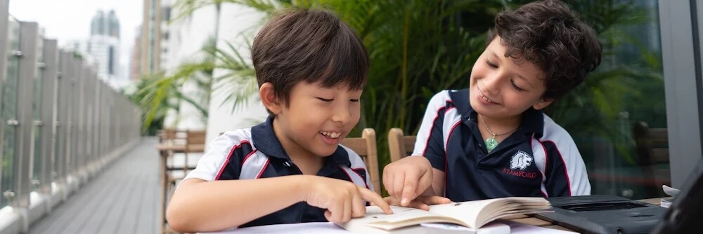 Elementary students reading at Stamford HK