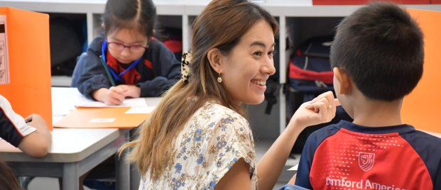 teacher helping student with school work