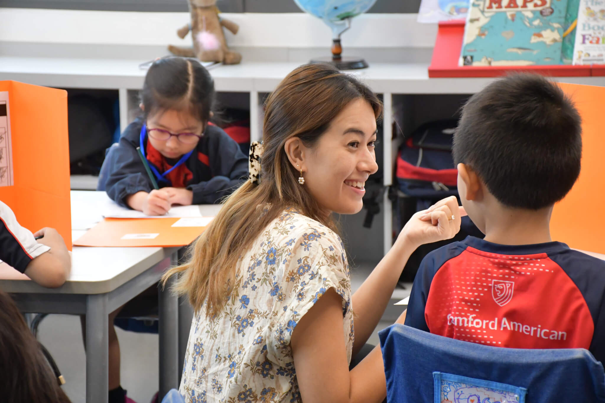 teacher helping student with school work